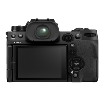 Mirrorless camera with articulating LCD screen shown from rear three-quarter view.