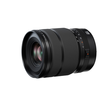 Black telephoto zoom lens with ribbed rubber focus ring and distance scale markings.