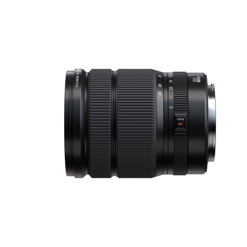 Black telephoto zoom lens with ribbed barrel and focus ring, photographed against white background.