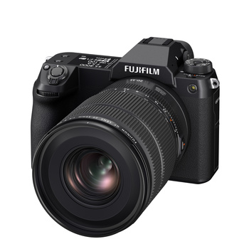 Fujifilm GFX mirrorless camera with attached zoom lens on white background.