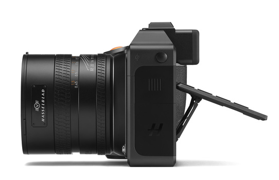Black mirrorless camera with attached telephoto lens shown from the side profile.