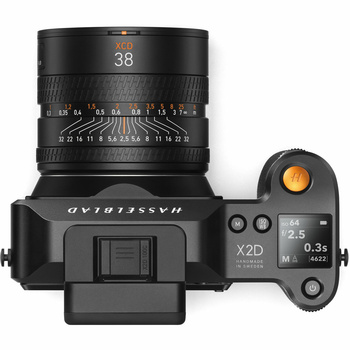 Top-down view of a mirrorless camera body with attached 38mm lens and articulating LCD screen.