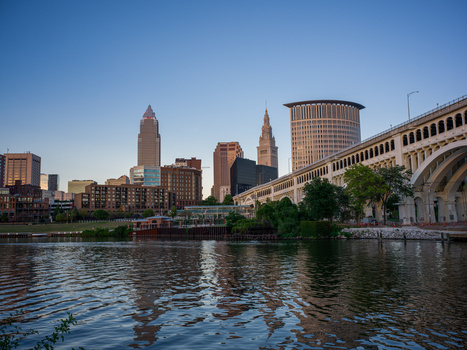 Cleveland skyline with distinctive terminal tower and arched bridge spanning the Cuyahoga River.