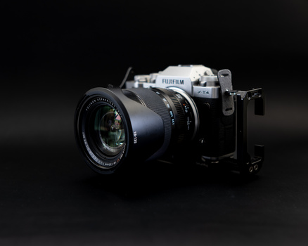 Fujifilm GFX medium format camera with attached lens against dark background.