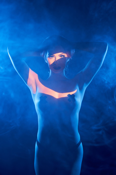 Silhouetted figure with glowing orange accent lighting against deep blue background.