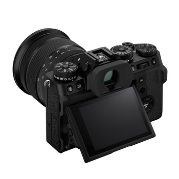 Mirrorless camera with articulating screen and attached wide-angle lens, shown from rear three-quarter view.