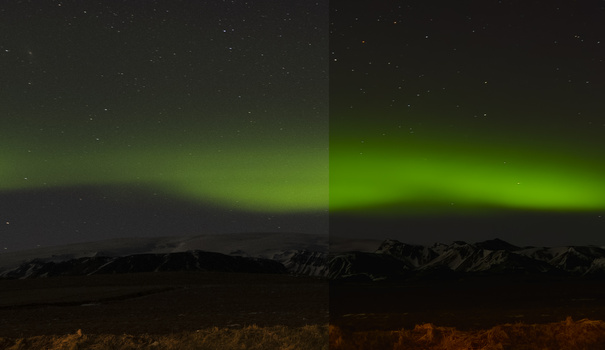 Northern lights glowing green above a dark mountain range silhouetted against a starry night sky.