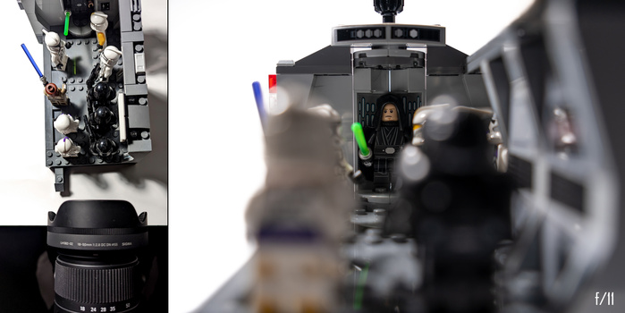 LEGO minifigure of Darth Vader positioned in a diorama with camera lens and lighting equipment visible.