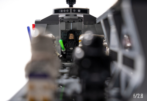 LEGO minifigures inside a detailed spacecraft cockpit with shallow depth of field.
