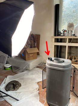 Studio setup with softbox lighting positioned over a cylindrical object on a white surface.