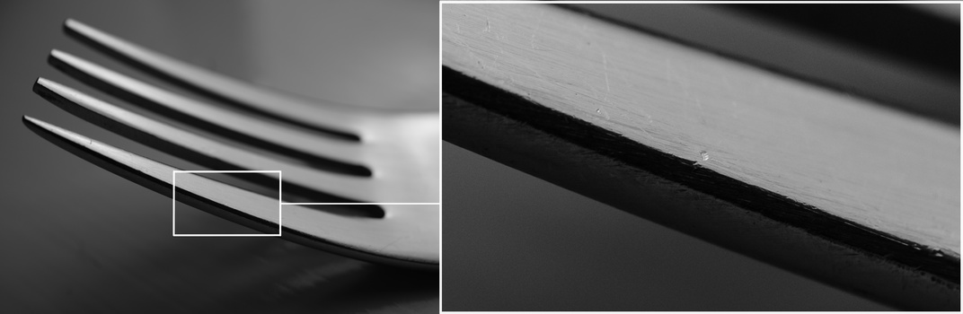 Macro detail of sharp pencil tips showing graphite points and wood shavings in black and white.