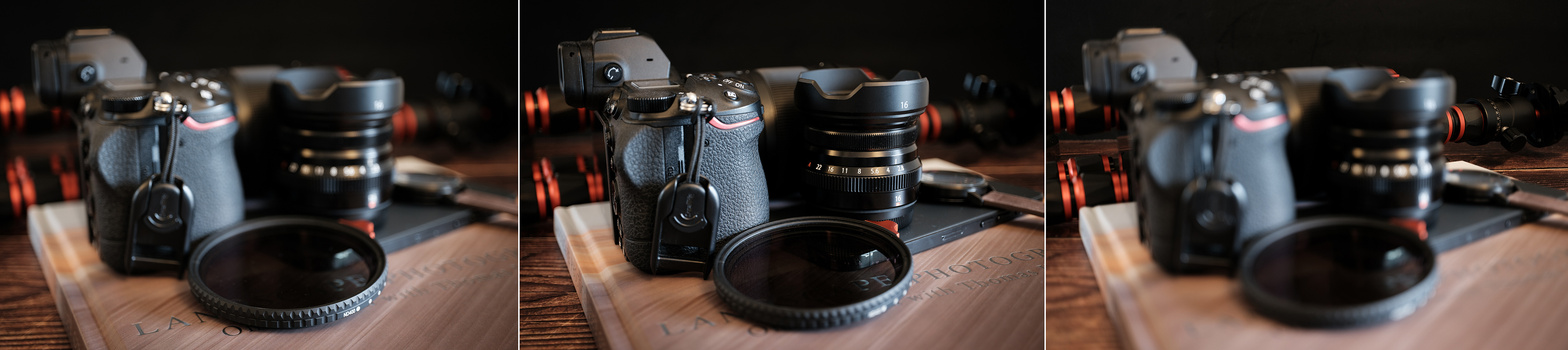 Photography equipment arranged on wooden surface with warm studio lighting and shallow depth of field.