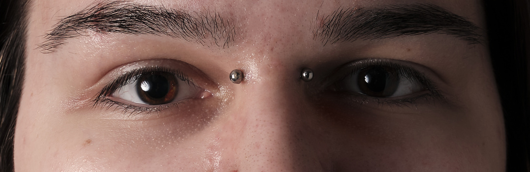Close-up of a person's eyes showing detailed skin texture, natural lighting, and subtle catchlights in the pupils.