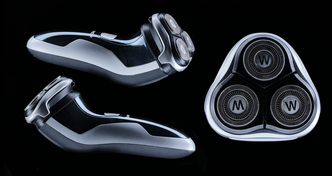 Three views of a modern electric razor with chrome finish and triangular head design against black background.