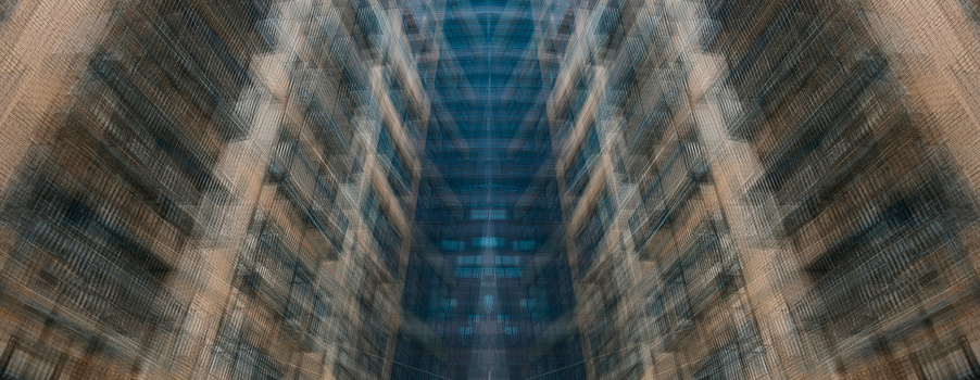 Symmetrical view down a narrow urban canyon between tall buildings with motion blur effect.