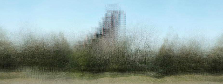 Modern high-rise building rising above bare trees in a misty landscape.