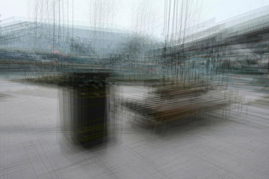 Blurred architectural scene with bridge structure and industrial elements in muted tones.