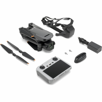 Drone with remote controller, batteries, propellers, and accessories laid out on white background.