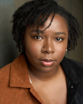 Professional headshot of a woman with natural lighting against a neutral background.