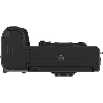 Top-down view of a black mirrorless camera body showing the left side with grip and port covers.