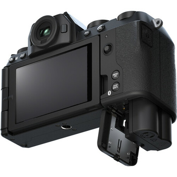 Black mirrorless camera shown from rear angle with articulating touchscreen display extended and electronic viewfinder visible.