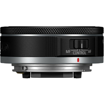 Top view of a compact camera lens with manual focus and autofocus controls visible on the barrel.