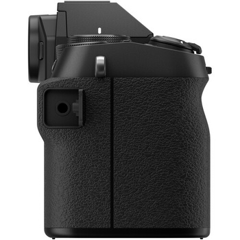 Mirrorless camera with textured black grip and articulating screen viewed from rear three-quarter angle.