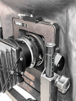 Vintage rangefinder camera mounted on a studio copystand with adjustable column and lighting setup.
