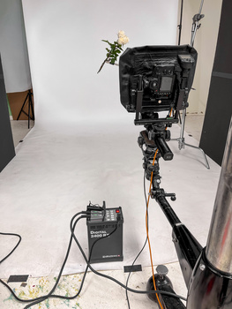 Professional video production setup with cinema camera mounted on jib arm and wireless audio receiver on stand.