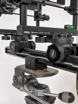 Modular camera rig with multiple lenses mounted on horizontal rails and support structures.