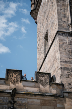 Architectural detail of stone building facade with ornamental carved panels against blue sky.