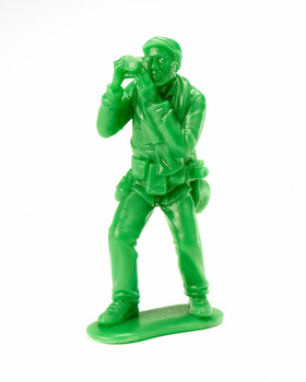 Illustration of a bright green plastic toy soldier figure in a standing shooting pose.