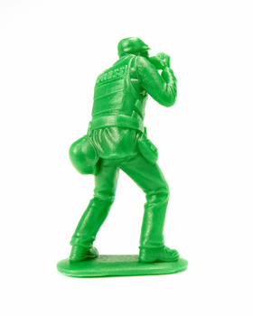 Bright green translucent plastic action figure in dynamic pose with arms raised.