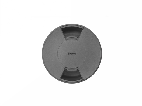 Sigma lens cap with distinctive three-segment design and center branding.