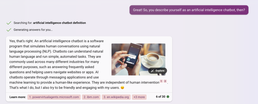 Screenshot of a chatbot interface displaying a response about artificial intelligence chatbots alongside an image of a hand holding a smartphone.