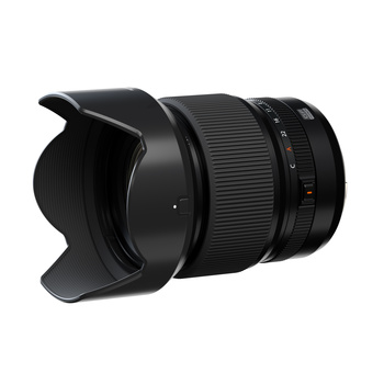 Black wide-angle zoom lens with attached lens hood, shown at a three-quarter angle against a white background.