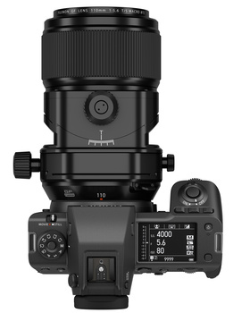 Top-down view of a mirrorless camera with mounted telephoto lens and tilt-shift adapter.
