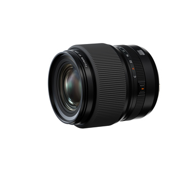 Black zoom lens with ribbed barrel and focus ring, shown at three-quarter angle against white background.