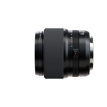 Black telephoto zoom lens with ribbed focus ring and distance scale markings on white background.