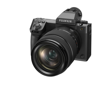 Fujifilm mirrorless camera with attached zoom lens on white background.