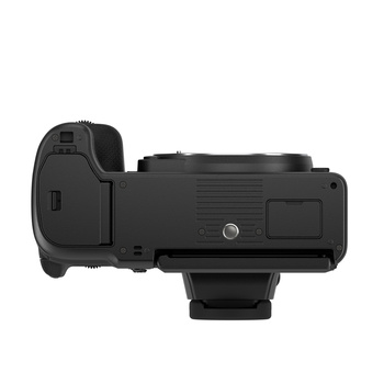 Top-down view of a black mirrorless camera body showing the grip, control wheel, and hot shoe mount.