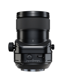 Large format camera lens with focusing mechanism and control knobs, displayed against white background.