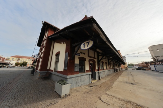 Half-timbered railway station building with dark wooden beams and light-colored walls, platform number 17 visible.