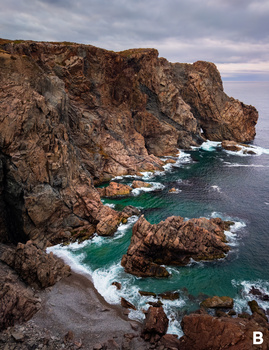 Rugged coastal cliffs with turquoise water and white waves crashing against rocky formations.
