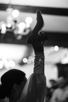Silhouetted arm raised against blurred bokeh lights in monochrome.