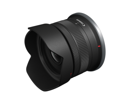 Wide-angle camera lens with black barrel and attached lens hood, shown against white background.