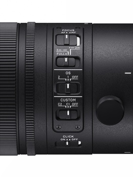 Close-up of camera lens control panel showing focus mode, AF/MF switch, and custom settings buttons.