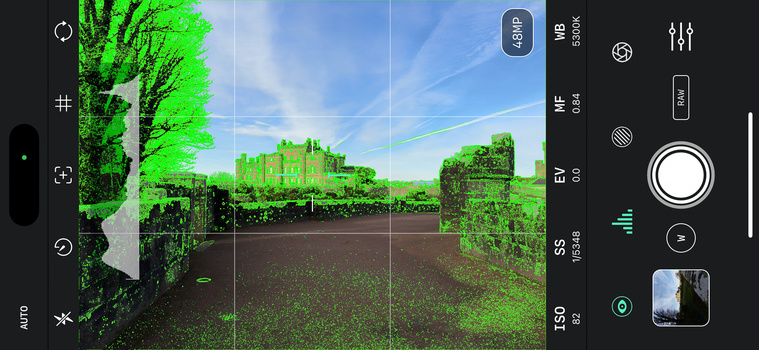 Screenshot of a smartphone camera app displaying a landscape scene with vivid green color grading applied.