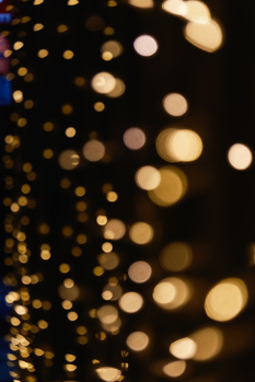 Bokeh circles in warm golden and amber tones blurred against a dark background.