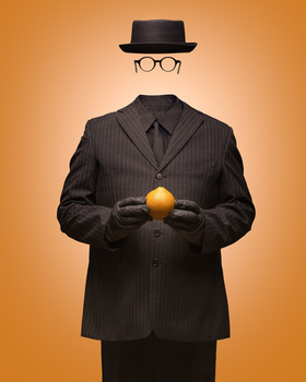 Illustration of faceless businessman in pinstriped suit holding golden sphere against warm orange background.